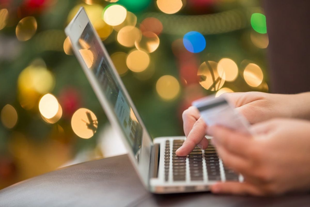 Person entering credit card information on computer