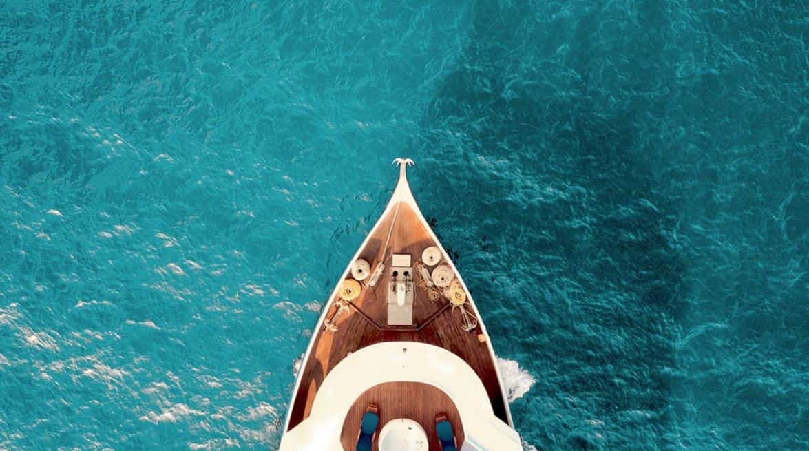 Boat floating on blue ocean