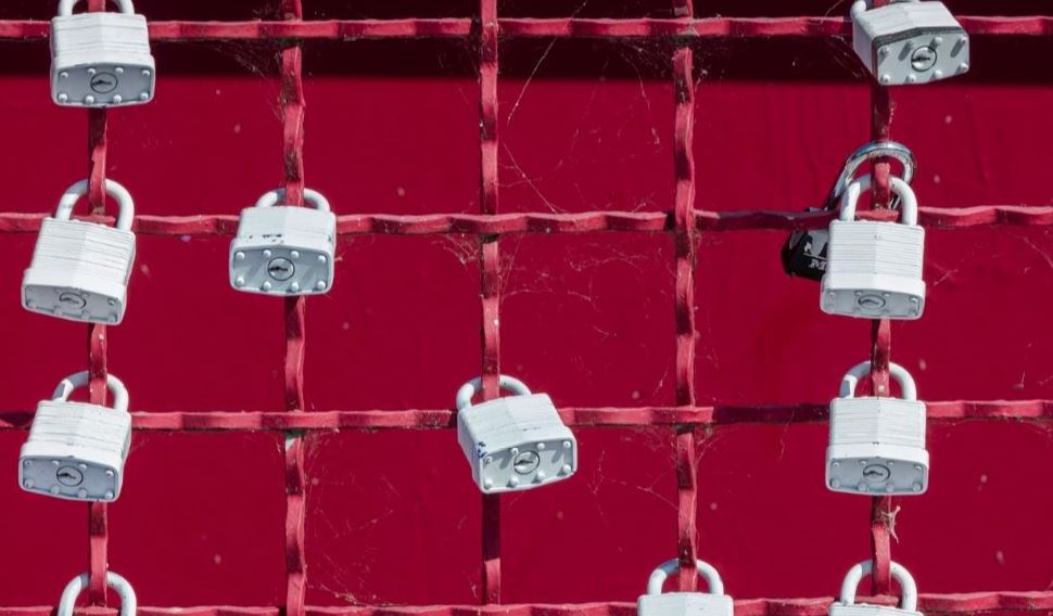 White locks hanging on red wall