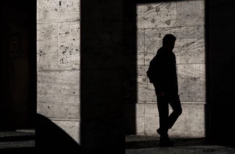 Man shadow reflects on the concrete wall